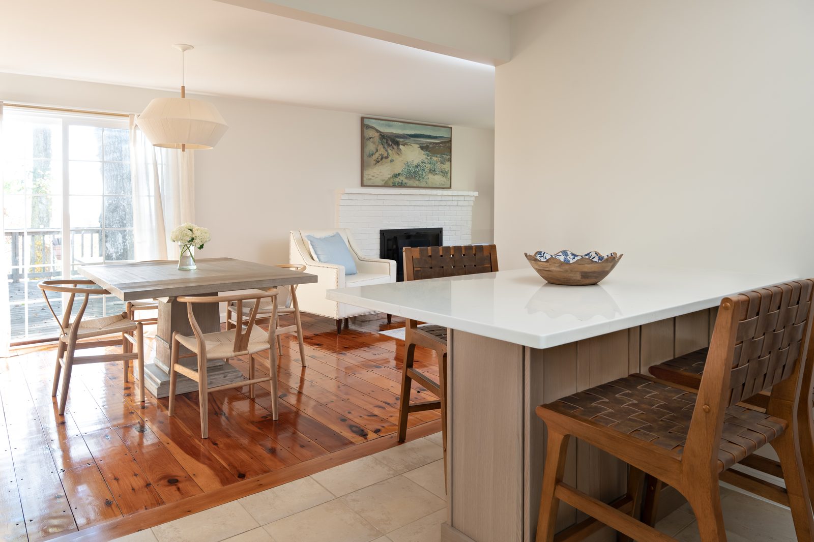 Indian Road open-plan kitchen and living area with original pine floors, fireplace, and coastal light