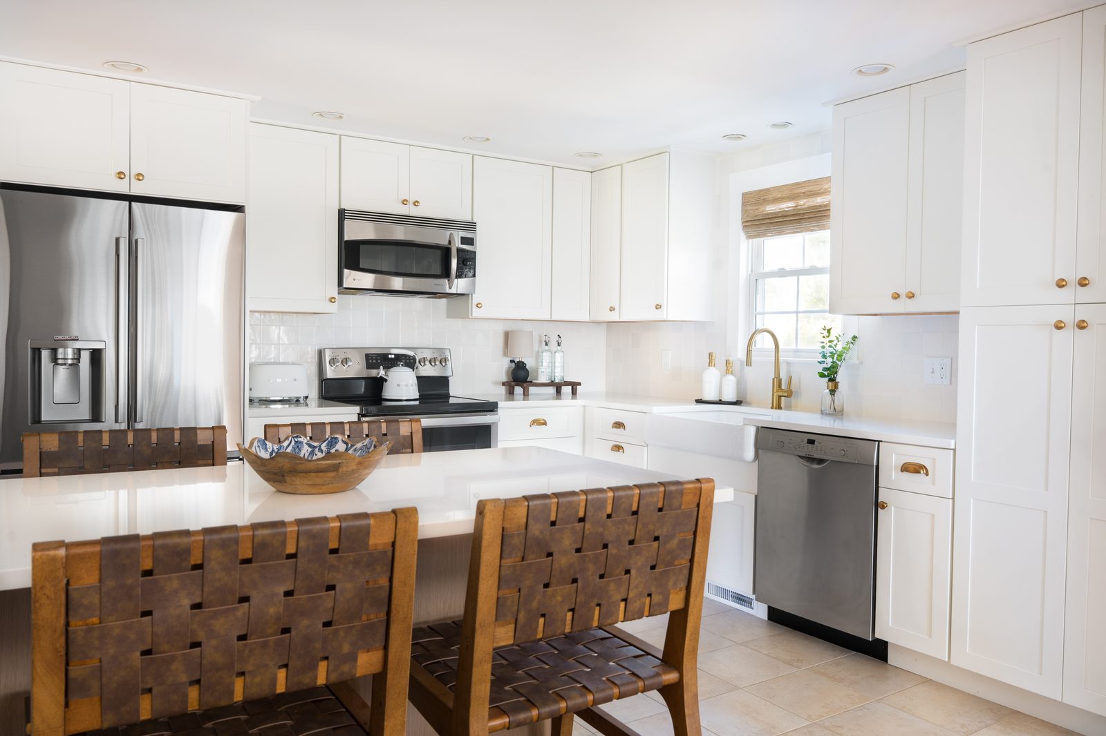 Indian Road kitchen with white shaker cabinetry, gold hardware, white subway tile backsplash, and farmhouse sink