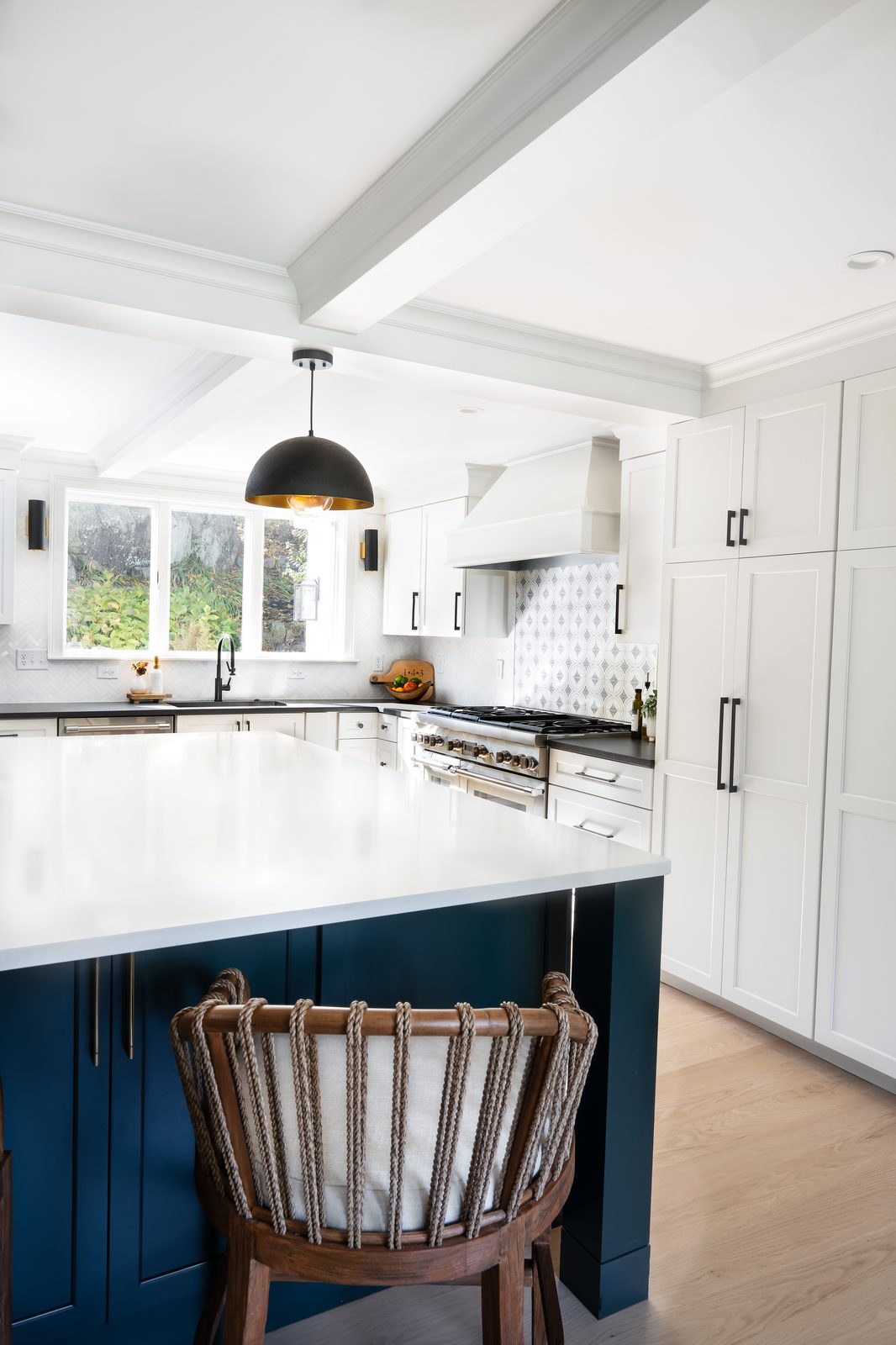 Jerusalem Road kitchen showing rich blue-green island in foreground, stainless range, and white upper cabinetry