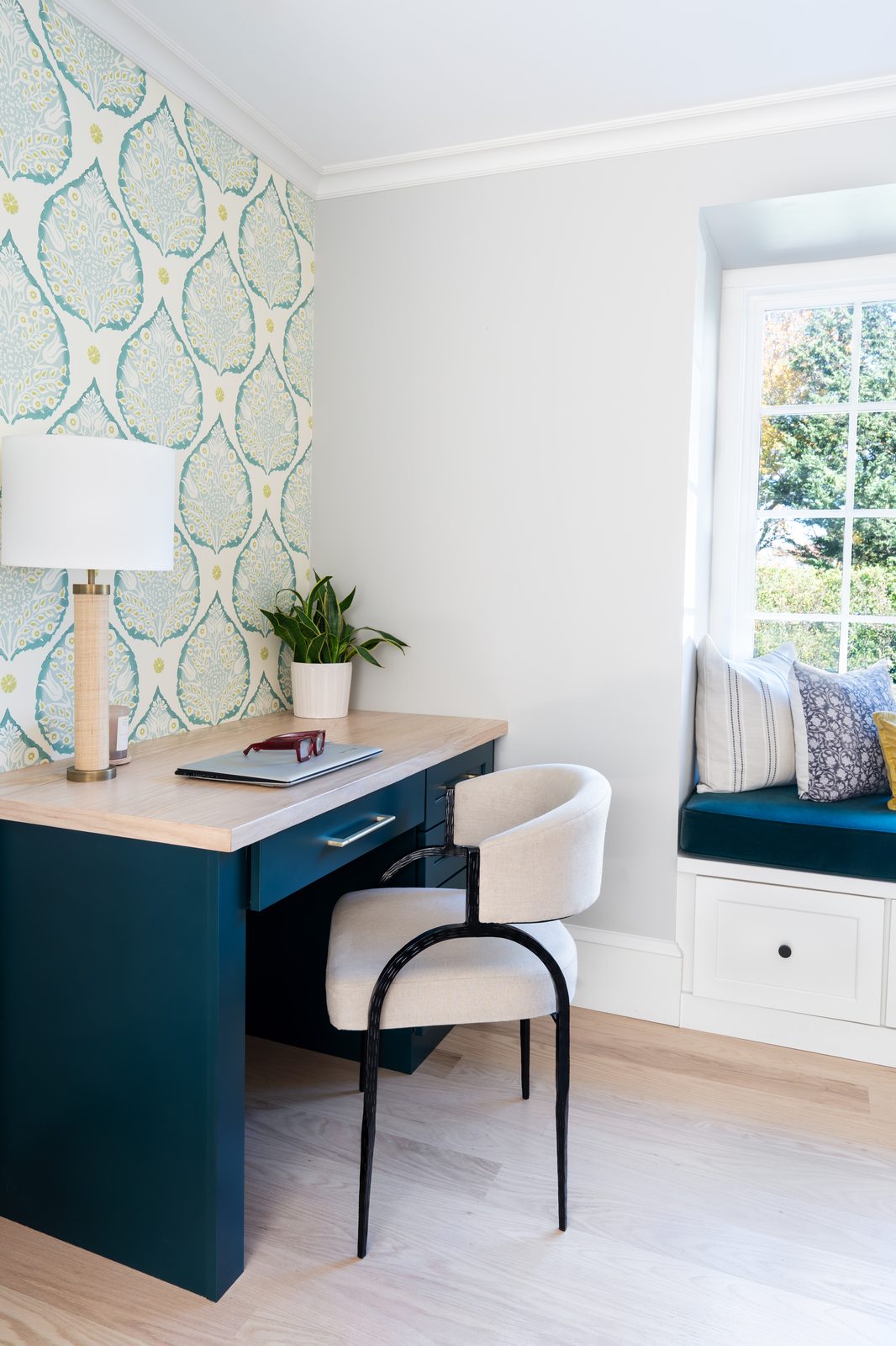 Jerusalem Road home office with rich blue-green built-in desk, botanical wallpaper accent wall, and window seat