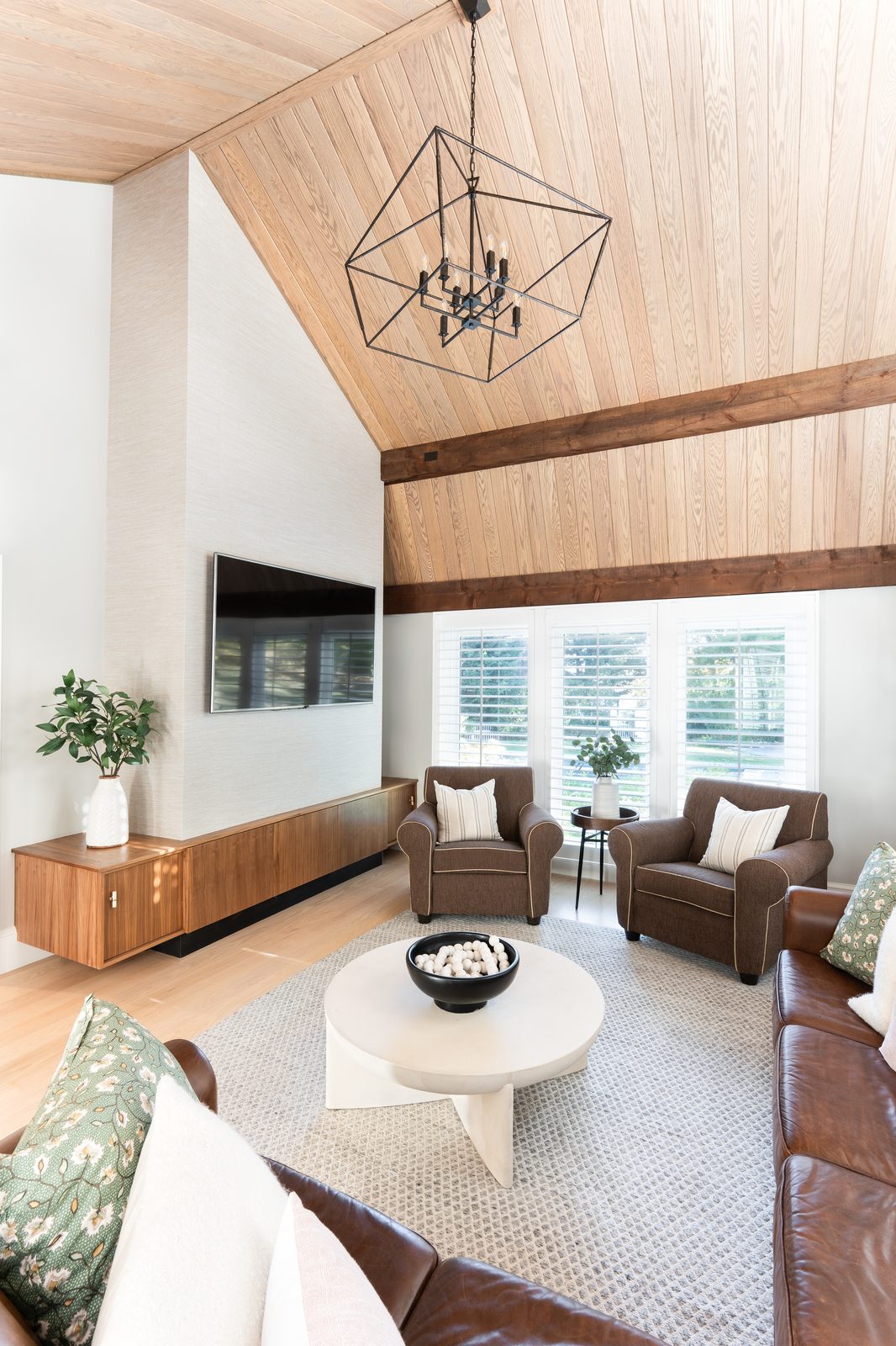 Jerusalem Road living room with vaulted white oak plank ceiling, dark wood beam, and leather seating