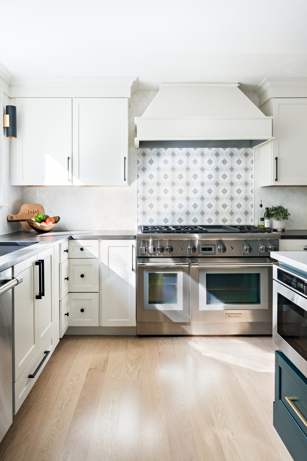 Jerusalem Road kitchen range wall with custom white hood, stainless range, and patterned circle tile backsplash