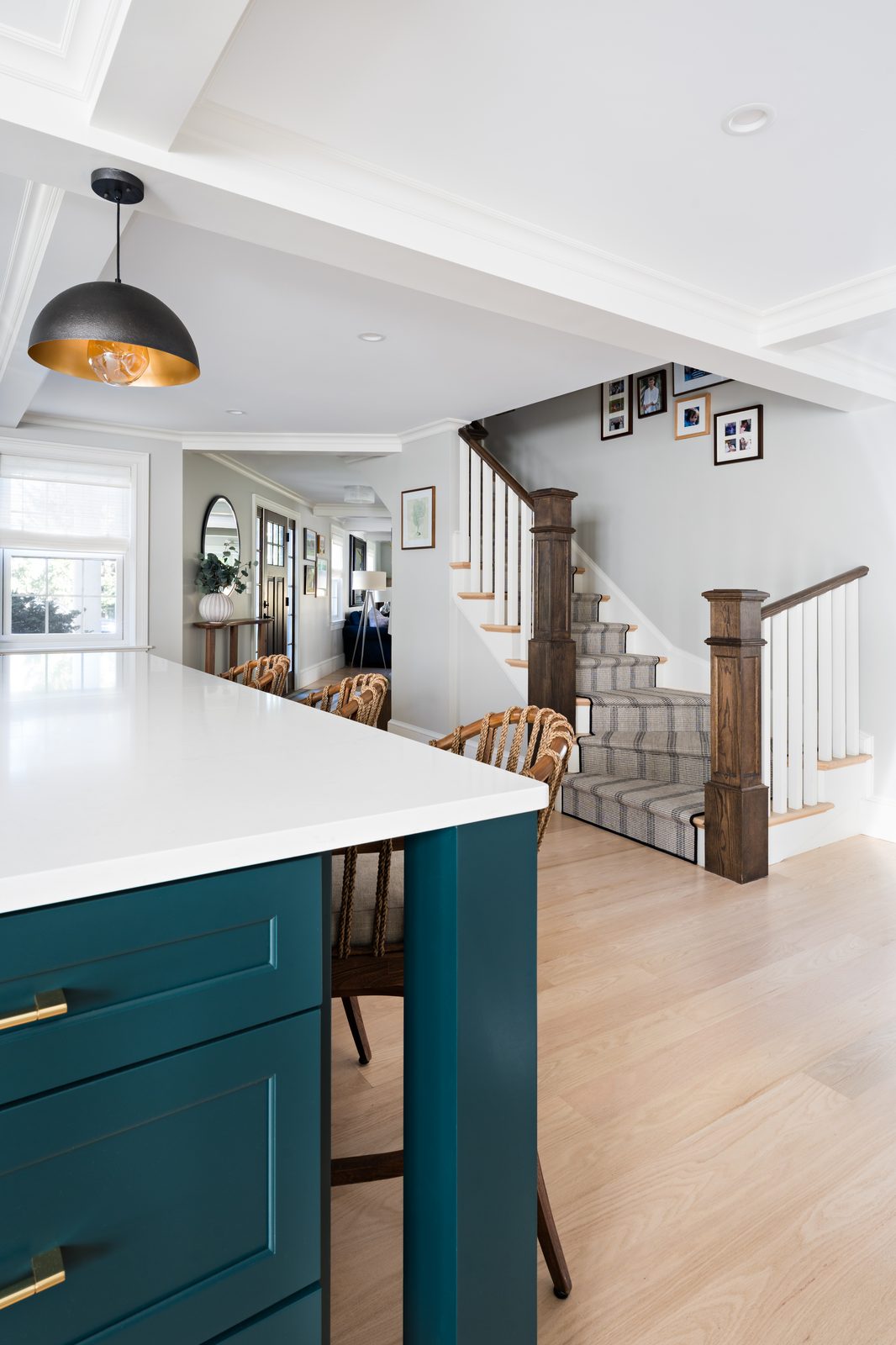 Jerusalem Road kitchen island with teal cabinetry and brass hardware, looking toward the staircase